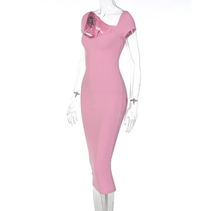 Close-up of pink ribbed knit fabric texture on a slim-fit short sleeve dress