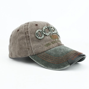 Detail view of vintage OCEAN embroidery and stitching on a distressed baseball cap