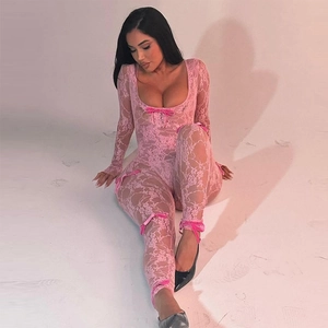 Detail of pink floral lace bodysuit with velvet ribbon bows on a slim fit garment