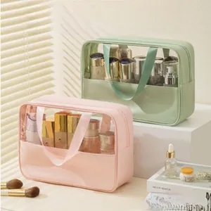Pink and mint green waterproof toiletry bags with clear PVC panels and handles