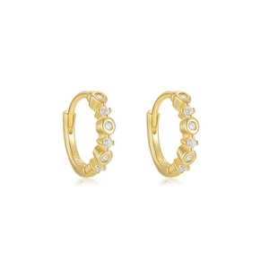 Macro detail of S925 sterling silver gold-plated hoop earrings with sparkling cubic zirconia