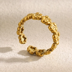 Detail of 18K gold plated stainless steel flower ring with adjustable open design
