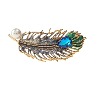 Elegant gold leaf hair clip with turquoise finish, white pearl, and blue teardrop gemstone