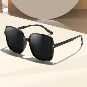 Classic black square oversized sunglasses with UV protection on geometric beige display