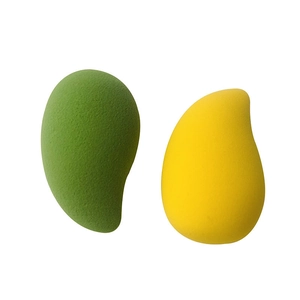 Detail of mango-shaped makeup sponges in yellow and green for smooth blending