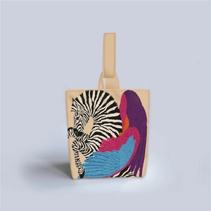 Detailed view of beige canvas tote bag featuring a colorful winged zebra illustration