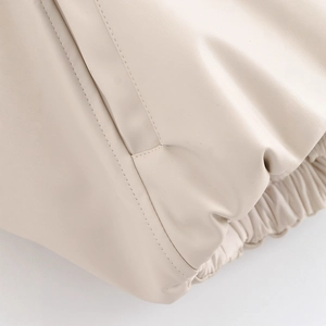 Chic beige faux leather varsity jacket with ribbed hem and high-quality pocket stitching