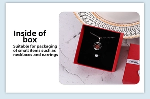 Red square jewelry gift box with black velvet lining and white printed bow ribbon detail