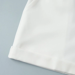 Detailed macro view of premium white twill fabric texture and fixed rolled cuff hem
