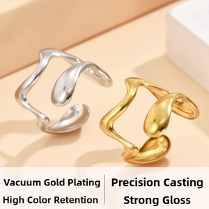 Close-up of wavy irregular open rings in gold and silver finish with polished metal texture