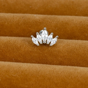 Macro shot of silver crown stud earring with five marquise-cut sparkling zircons