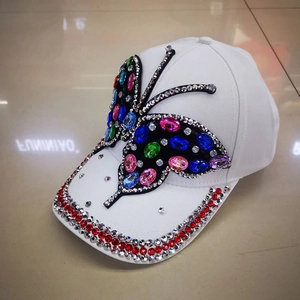 White baseball cap with colorful rhinestone butterfly and jeweled brim for outdoor sun protection