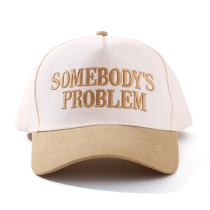 Close-up of golden 3D embroidery on contrast cotton twill adjustable baseball cap