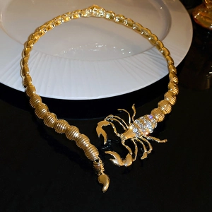 Detailed view of a gold-tone scorpion choker with sparkling rhinestone embellishments