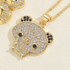 Close-up of golden panda pendant with pavé set white and black zircon stones