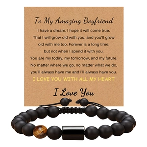 Macro view of matte black beads and tiger eye stone bracelet with greeting card message
