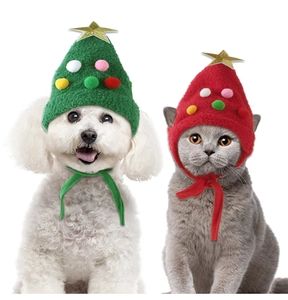 Close-up of green and red knitted Christmas tree hats with golden stars for dogs and cats