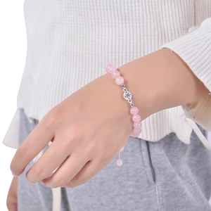 Detail of pink crystal beaded bracelet with compass charm on wrist for graduation gift