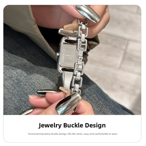 Detail shot of the stainless steel square watch jewelry clasp and H-link silver band