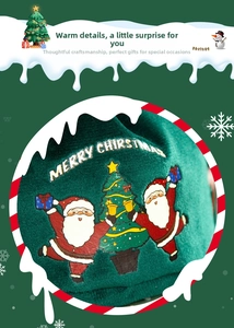 Detail of green velvet bag featuring embroidered Santa Claus and Merry Christmas text