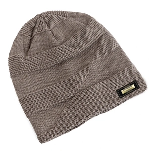 Detailed close-up of dark beige knit beanie with a classic fashion metallic logo tag