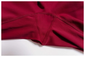 Detailed gusset stitching on high-waist yoga pants in dark red high-density fabric