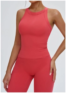 Close-up of coral red yoga set featuring cross-back vest and high-waist leggings detail