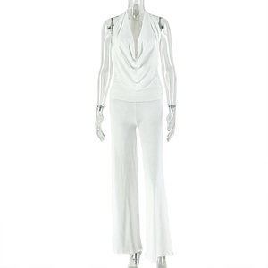 Detail of white halter neck top with draped cowl neckline and wide leg trousers set