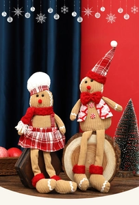 Detail of Christmas gingerbread plush dolls with corduroy texture and plaid festive outfits
