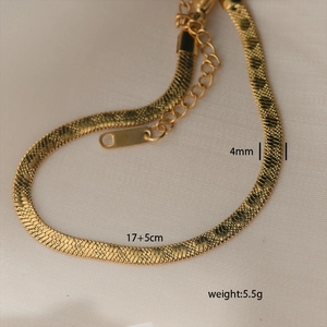Detail of 4mm gold-plated snake chain anklet showing lobster clasp and extension links