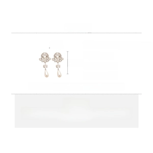 Detail view of floral pearl drop earrings with rhinestones and silver needles