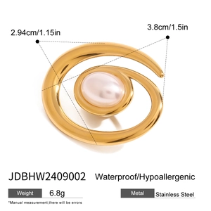 Macro shot of 18k gold spiral brooch with a white pearl on a waterproof stainless steel base