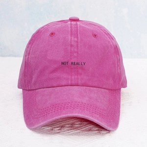 Detail of NOT REALLY embroidery on rose red washed cotton canvas Y2K baseball cap