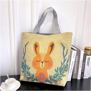 Canvas tote bag with cute rabbit and floral patterns in a lifestyle setting
