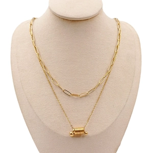 Double-layered gold necklace with paperclip chain and cylindrical spring pendant