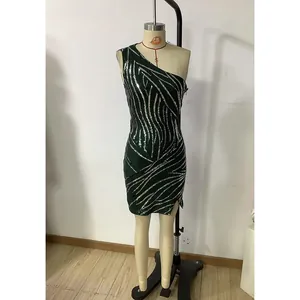 Detail of green sequin one-shoulder mini dress with shimmering zebra pattern texture