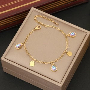 Macro view of gold-plated chain with purple drop pendants on a jewelry display box