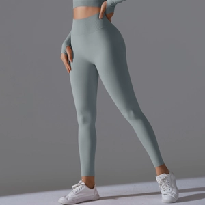Detail view of high-waist seamless yoga pants with thumb-hole sleeves in matte grey