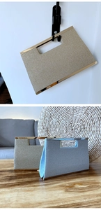 Close-up of sparkling woven evening clutch bags with metallic handles in gold and silver