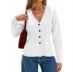 Detail of white V-neck knit cardigan with black buttons and ribbed cuffs on white backdrop