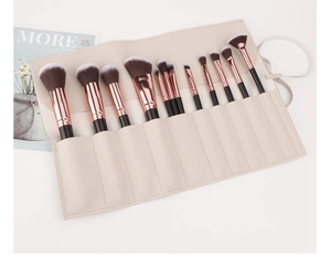 Detail of 11 professional makeup brushes in a beige lychee pattern PU leather roll-up case