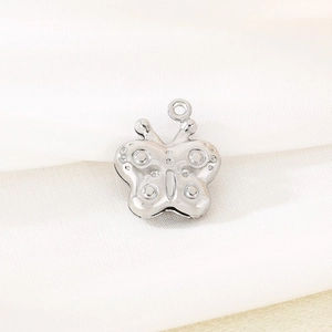 Macro shot of silver hollow butterfly charm with polished metallic finish for jewelry DIY