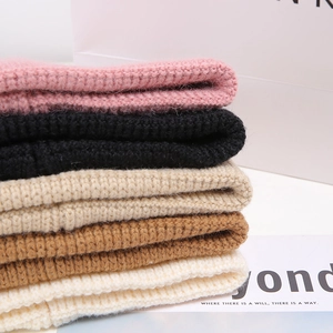 Chunky knit beanies in various colors including pink, beige and black for winter warmth