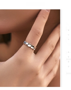 Close-up of minimalist S925 silver irregular fish scale ring worn on finger