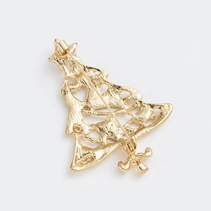 Close-up of golden Christmas tree brooch back showing secure pin and polished metal finish