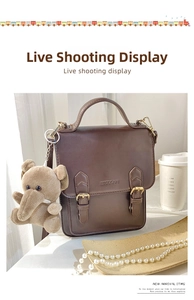 Brown vintage PU leather handbag featuring a cute small elephant plush charm accessory