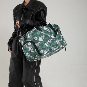 Large travel bag with skull and rose print worn by model for fitness and travel