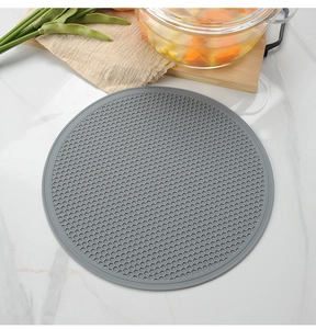 Macro detail of grey round honeycomb silicone heat resistant mat on marble surface