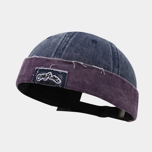 Retro denim docker cap in blue and purple with embroidery patch and raw edges