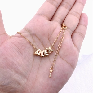 Customized KC gold alphabet necklace with ALEX pendant charms on adjustable metal chain